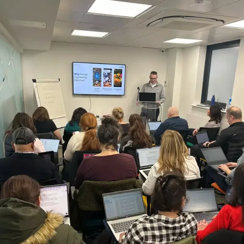Hartz AI bespoke training session with UK SME team members working on laptops