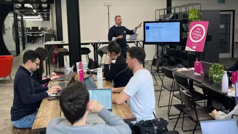 Participants using AI tools on laptops during a hands-on Hartz AI workshop